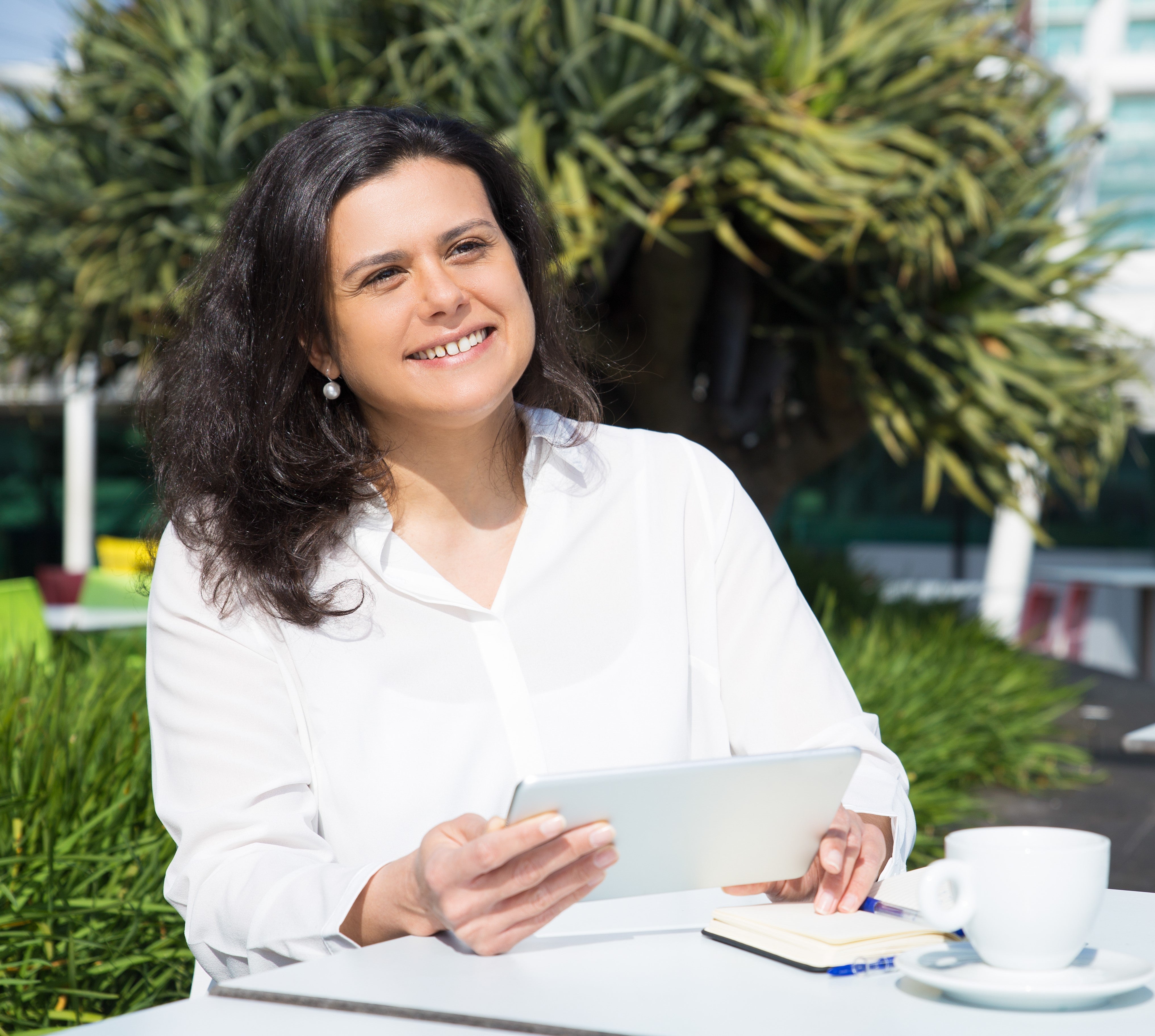 files/smiling-attractive-woman-working-using-tablet-street-cafe.jpg